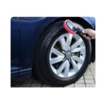 Long handle tire wax foam brush in red with an anti-slip grip for mess-free car detailing.